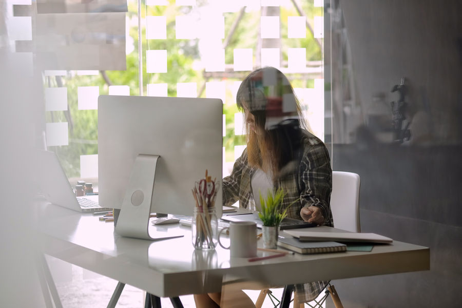 Team member working at a computer in a bright office